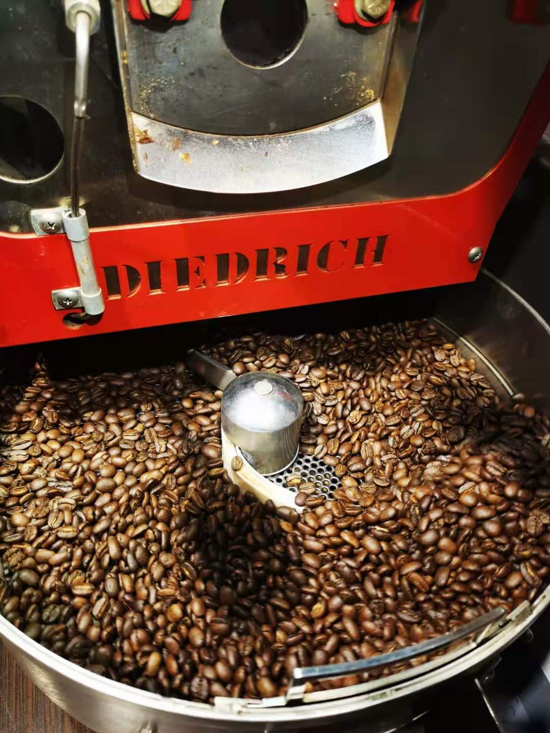 Coffee beans tumbling inside a drum roaster